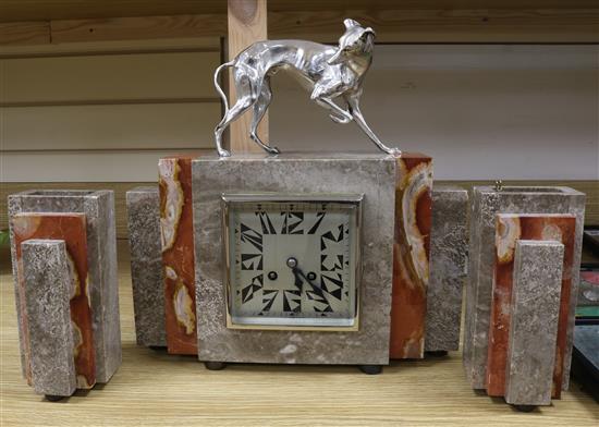 An Art Deco clock garniture with silvered bronze dog surmount